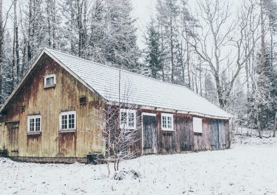 A wooden house in the snow.
